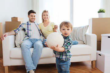 Image showing happy little boy with ball over parents at home