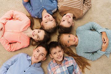 Image showing happy smiling children lying on floor in circle