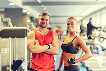 Image showing smiling man and woman in gym