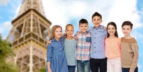 Image showing happy smiling children hugging over eiffel tower