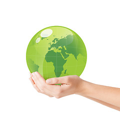 Image showing close up of woman holding green globe in her hands
