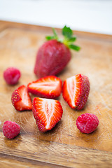 Image showing close up of ripe red strawberries on cutting board