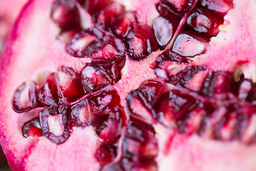 Image showing close up of ripe pomegranate cut with seeds