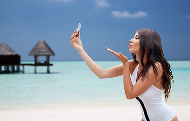 Image showing young woman taking selfie with smartphone