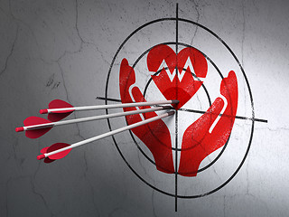 Image showing Insurance concept: arrows in Heart And Palm target on wall background