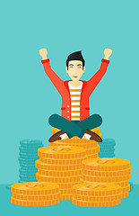 Image showing  Happy businessman sitting on coins.