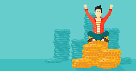 Image showing  Happy businessman sitting on coins.