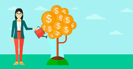 Image showing Woman watering money tree.