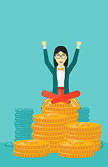 Image showing  Happy business woman sitting on coins.