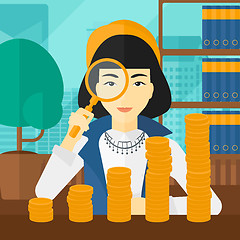 Image showing Woman with magnifier and golden coins. 