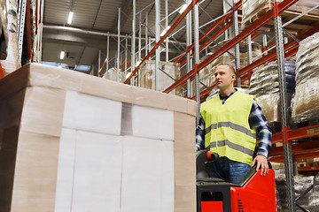 Image showing man with tablet pc operating forklift at warehouse