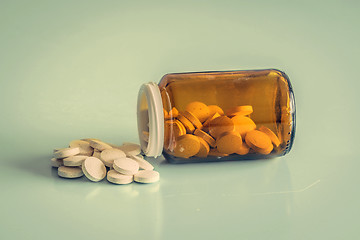 Image showing A glass of pills on a table