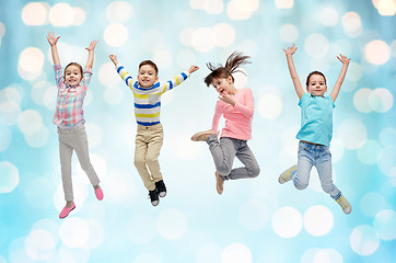 Image showing happy little children jumping over blue lights