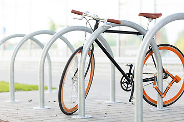 Image showing close up of bicycle locked at street parking