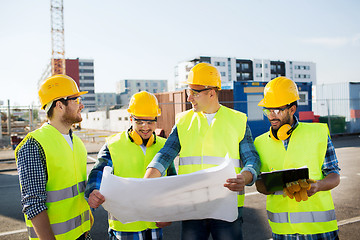 Image showing group of builders with tablet pc and blueprint