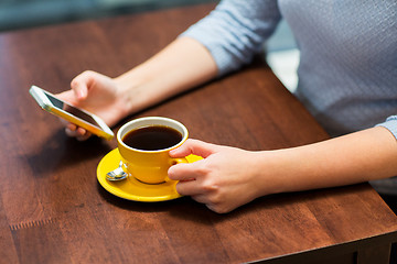 Image showing close up of woman with smartphone and coffee