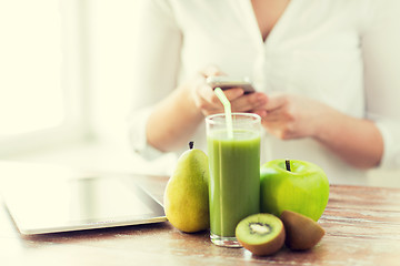 Image showing close up of woman with smartphone and fruits