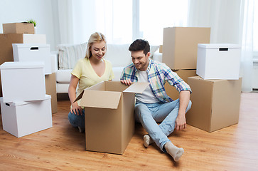 Image showing smiling couple with big boxes moving to new home