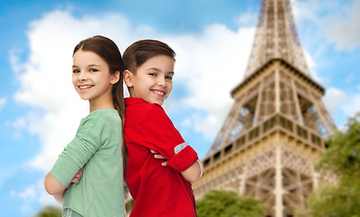 Image showing happy boy and girl standing over eiffel tower