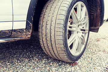 Image showing close up of dirty car wheel on ground