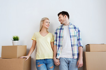 Image showing smiling couple with big boxes moving to new home