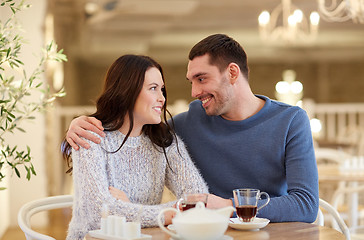 Image showing happy couple drinking tea at restaurant