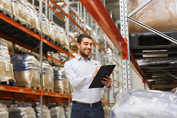 Image showing businessman with clipboard at warehouse