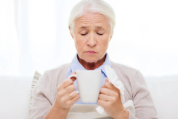 Image showing sick senior woman drinking hot tea at home