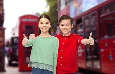 Image showing happy children showing thumbs up over london city