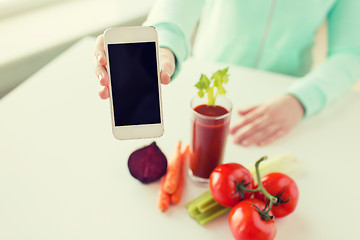 Image showing close up of woman with smartphone and vegetables