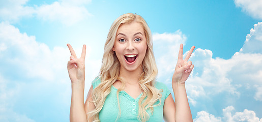 Image showing smiling young woman or teenage girl showing peace