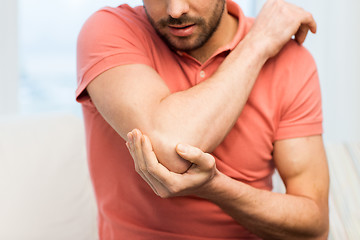 Image showing close up of man with injured hand at home