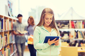 Image showing happy student girl with tablet pc in library