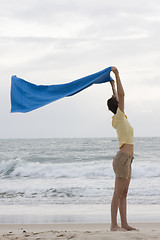 Image showing Woman with towel on beach