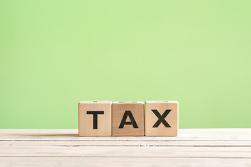Image showing Tax sign on a green background