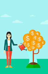 Image showing Woman watering money tree.