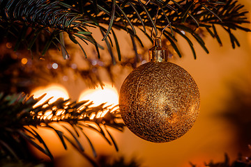 Image showing Golden Christmas ball hanging on the tree