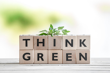 Image showing Think green sign with a plant