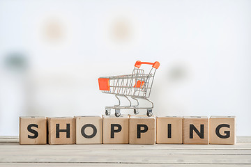 Image showing Shopping cart on a wooden sign