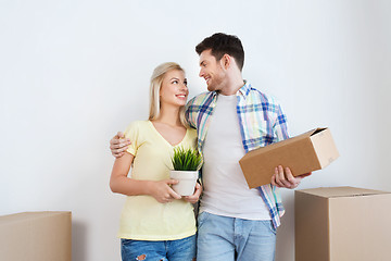 Image showing smiling couple with big boxes moving to new home