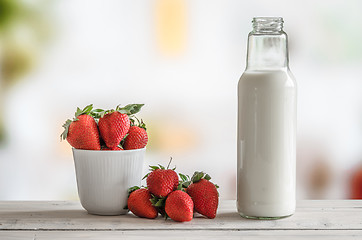 Image showing Strawberries and a bottle of milk