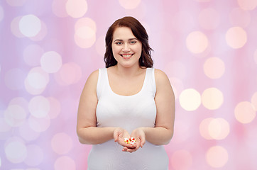 Image showing happy plus size woman in underwear with pills