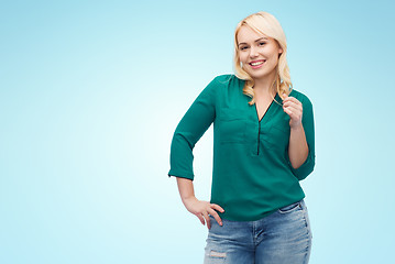 Image showing smiling young woman in shirt and jeans