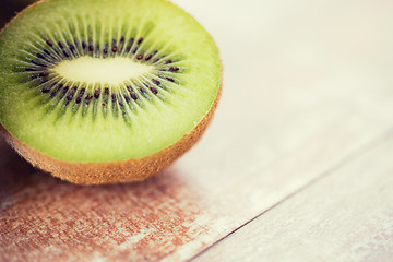 Image showing close up of ripe kiwi slice on table