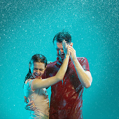 Image showing The loving couple in the rain