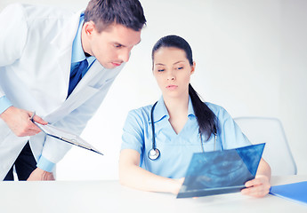 Image showing two medical workers looking at x-ray