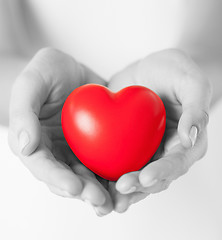 Image showing female hands with small red heart