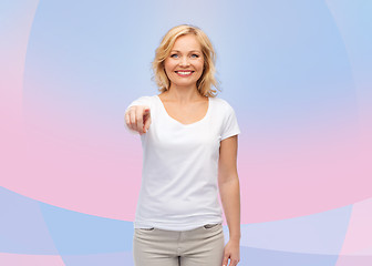 Image showing smiling woman in white t-shirt pointing to you