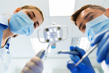 Image showing close up of dentist and assistant at dental clinic