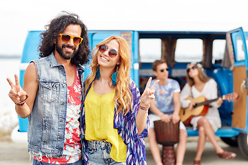 Image showing hippie friends over minivan car showing peace sign